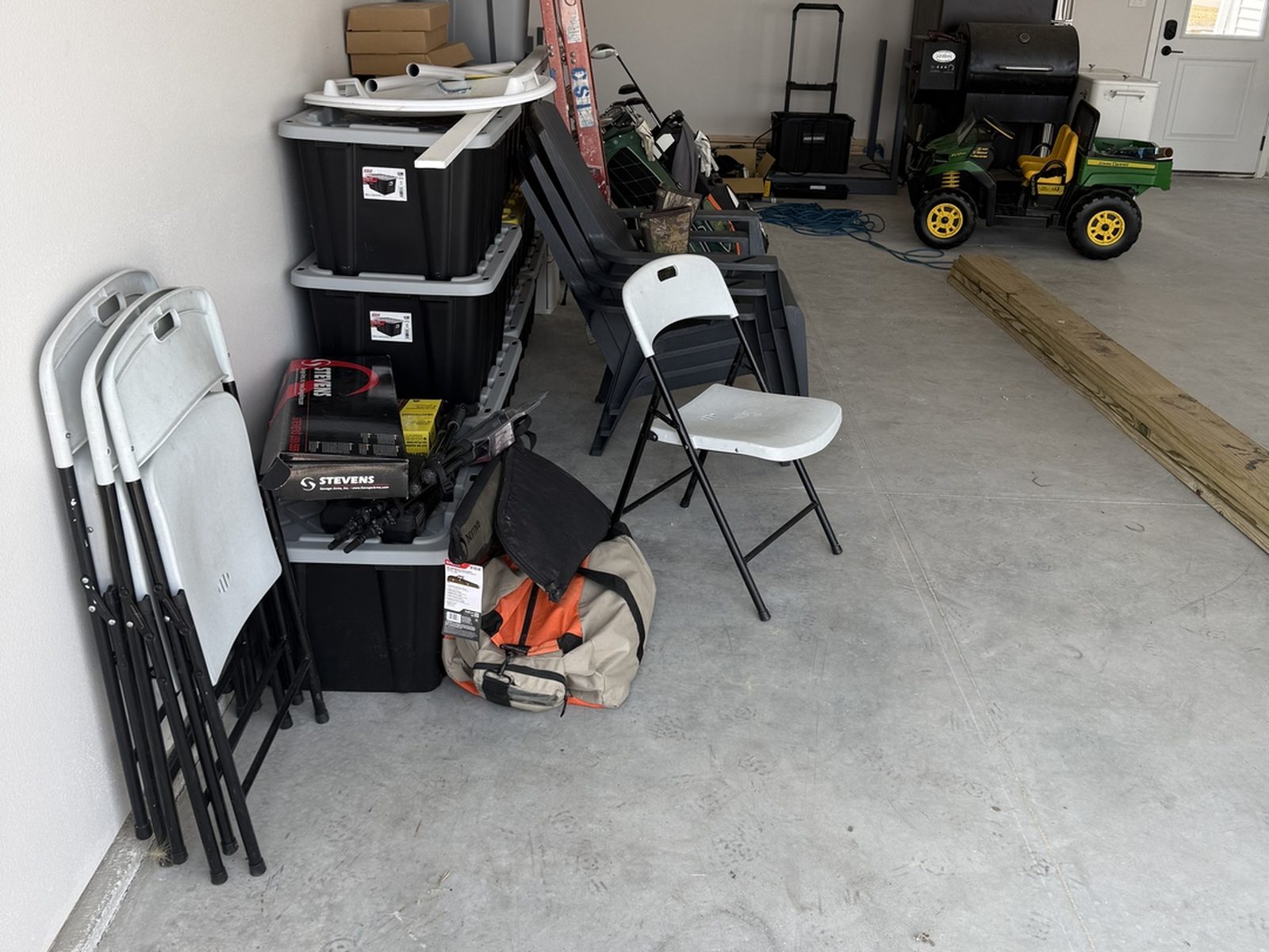 Before: bare side wall of the Mapleton, ND garage with equipment and lumber stacked against unfinished concrete
