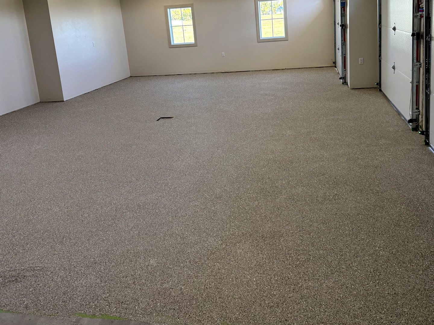 After: the same Reiles Acres, ND garage with a light gray full-flake epoxy floor wall to wall