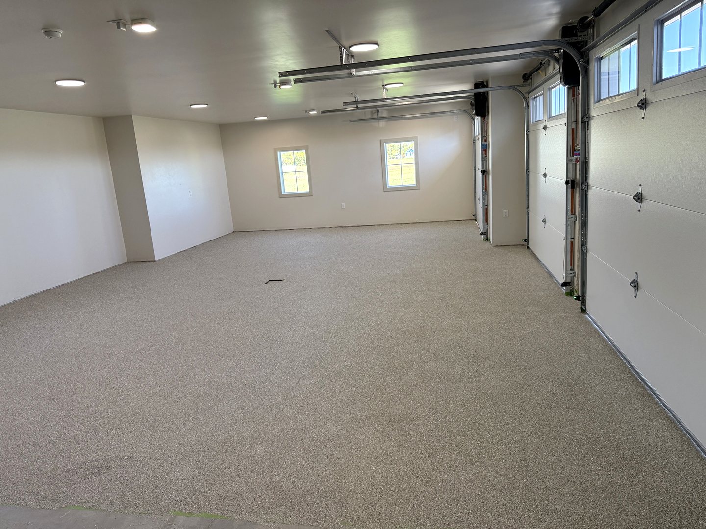 After photo of the same Reiles Acres ND garage with a light gray full-flake epoxy floor running wall to wall